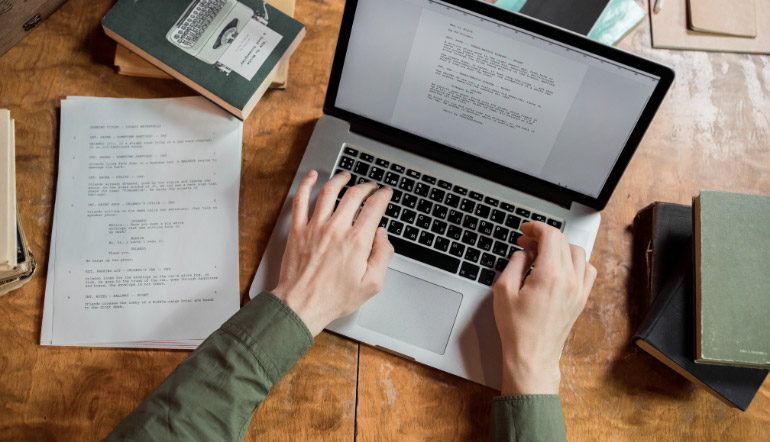 person typing using laptop