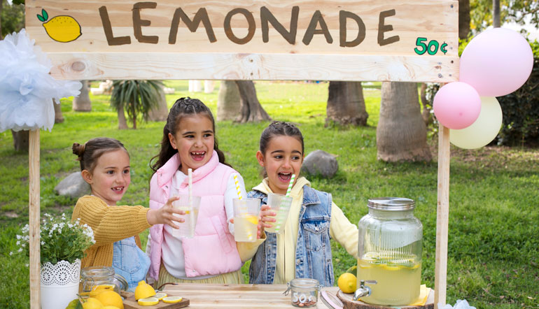 three little girls running lemonade stand