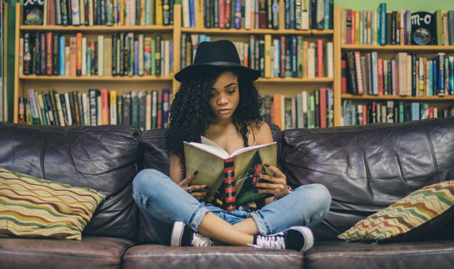 woman reading on couch