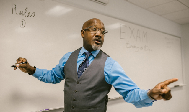 instructor writing on whiteboard