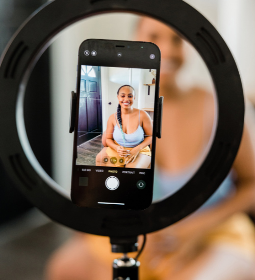 influencer recording herself on smartphone with ring light