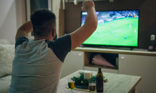 man watching football match on tv