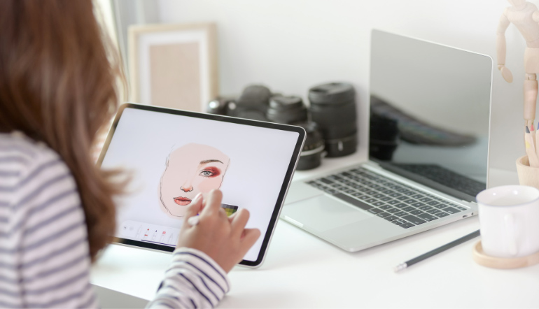 woman using graphic tablet in creative workspace