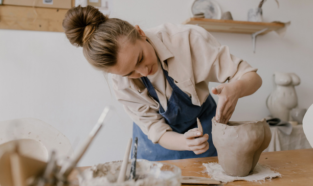 woman doing clay sculpting