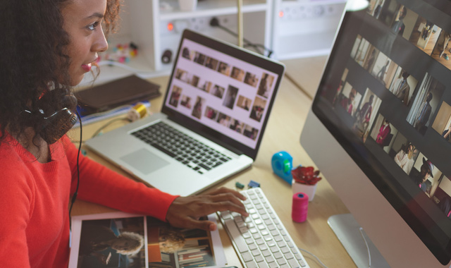 female graphic designer using graphic tablet at desk