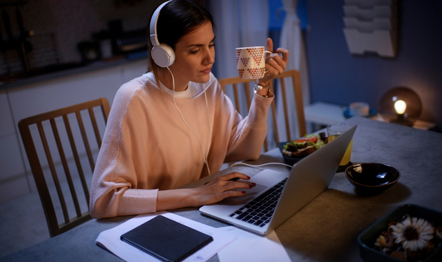 woman with a serious face looking at her laptop