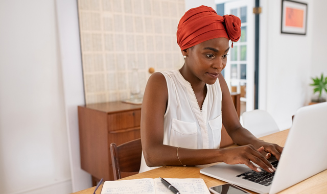 mature African woman working on laptop from home
