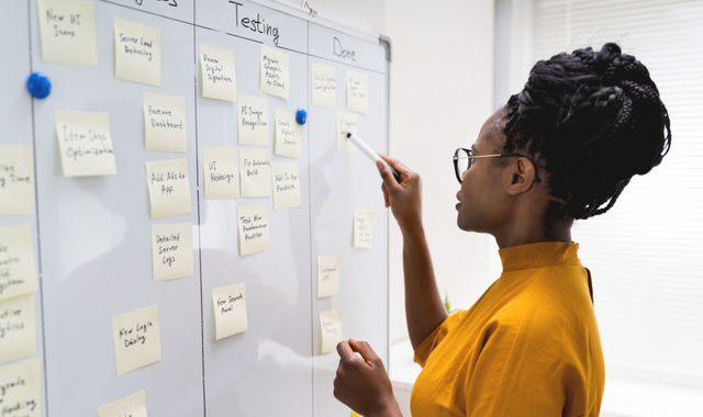 African woman writing plan