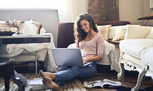 woman working on laptop in her living room