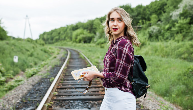 woman standing on train tracks