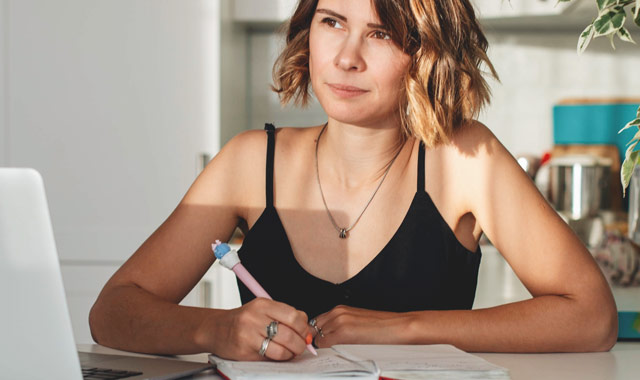 woman taking notes on her notebook