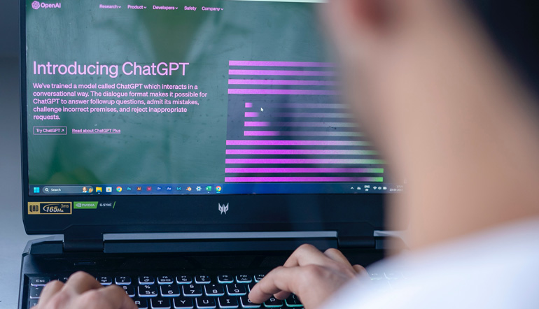 man sitting at a computer using ChatGPT