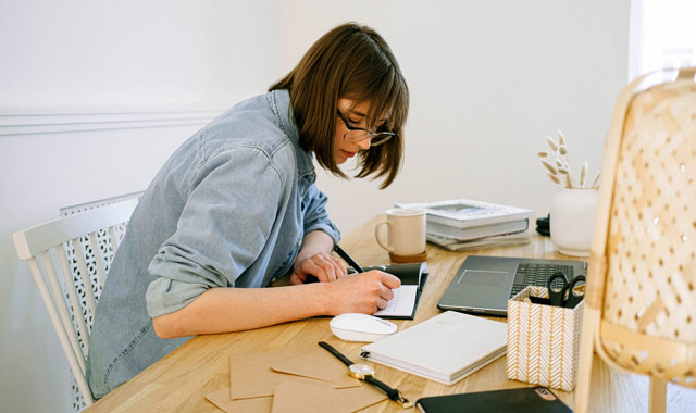 woman writing on a notebook