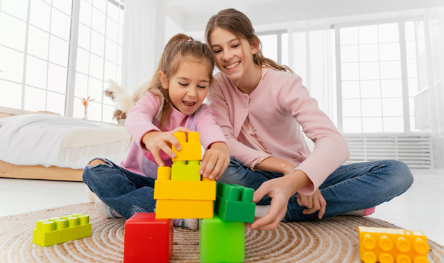 two girls playing block toys
