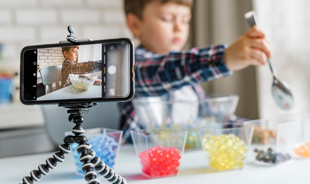 boy with hydrogel balls recording videos