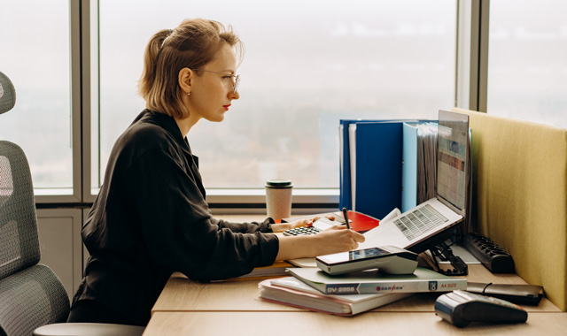 woman using laptop sitting at the table