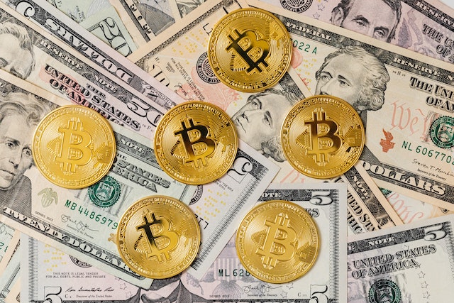 gold Bitcoin coins and paper money