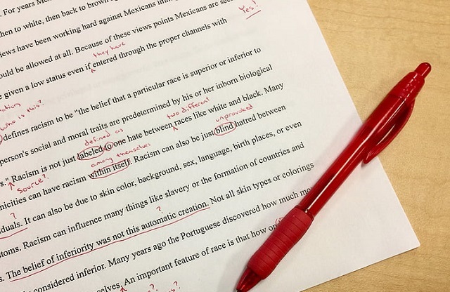 red pen on a typed paper with red markings