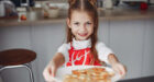 adorable little girl holding plate of cookies